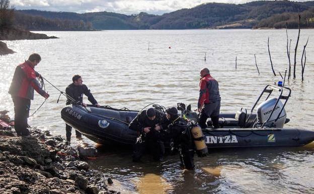 Buzos de la Ertzaintza, durante los trabajos de búsqueda de Jon Bárcena en el pantano de Urrunaga. // EFE