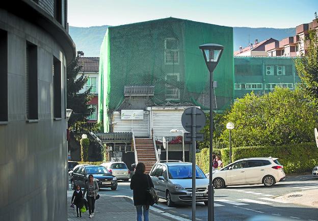 Traslado. El edificio de Emigración, cubierto por una malla verde para evitar desprendimientos. / DE LA HERA