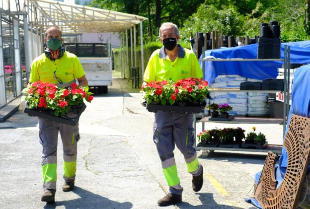 Dos trabajadores del servicio de jardinería transportan plantas en las instalaciones de Meaka. / F. DE LA HERA