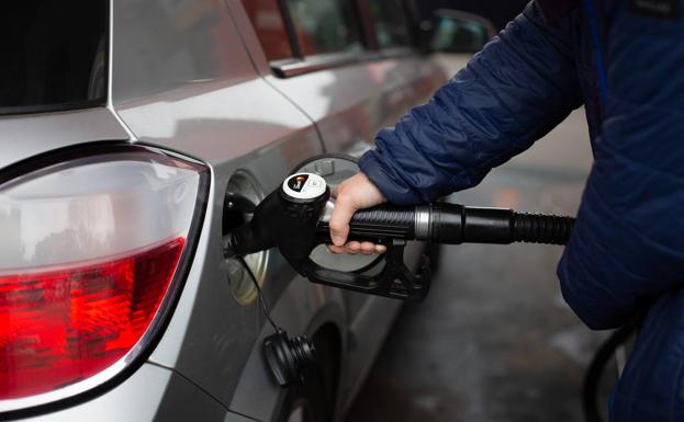 A man refuels his vehicle.