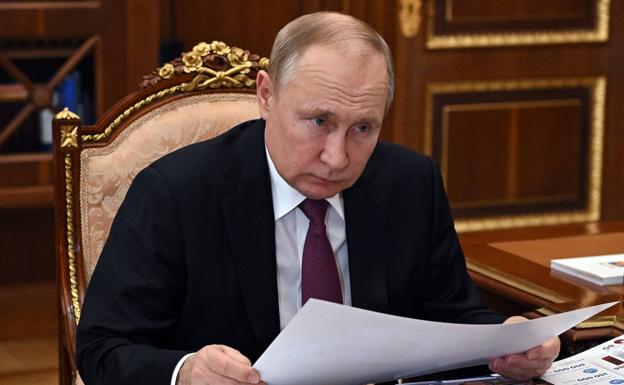 Vladimir Putin, conducting business in the Kremlin.