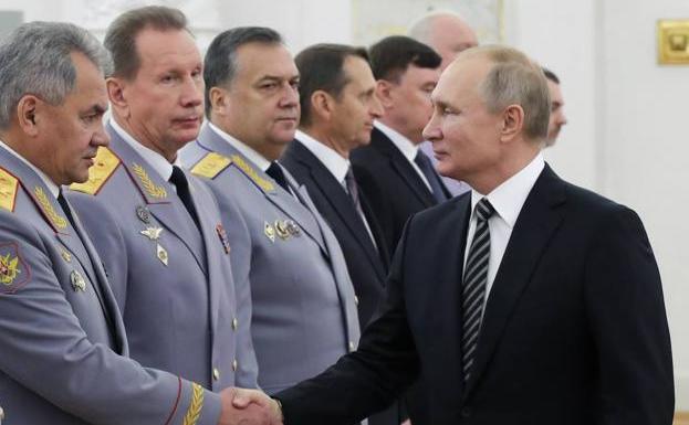 Sergei Shoigu (left) and Victor Zolotov, in a file image of an official act in Moscow with Vladimir Putin. 