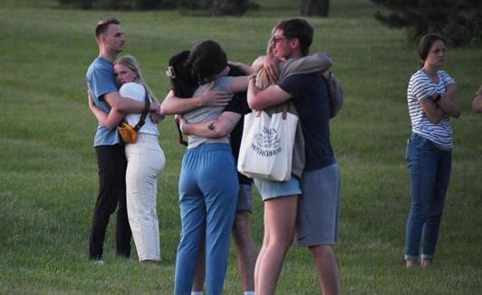 Survivors of the shooting embrace./REUTERS