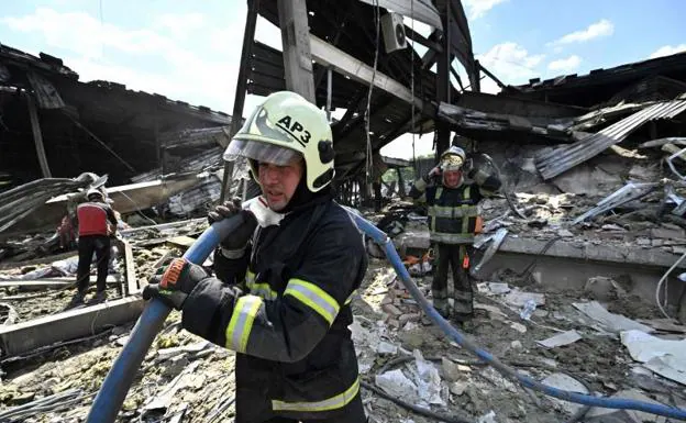 Firefighters examine the remains of the building in search of new victims. 