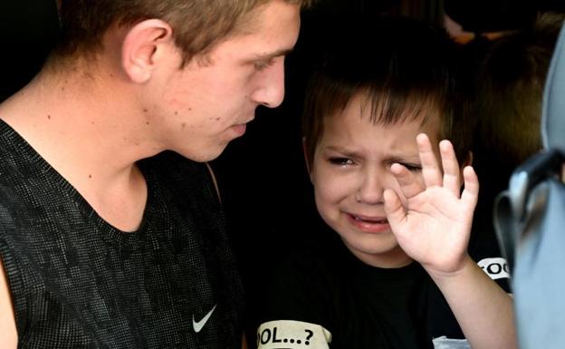 A little boy says goodbye to his mother before being evacuated from the city of Sloviansk. 