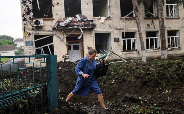 A woman walks through the rubble after a Russian bombardment in Kharkov. 