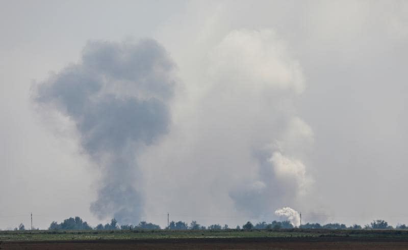 Two columns of smoke show the explosions in the ammunition depot in Crimea