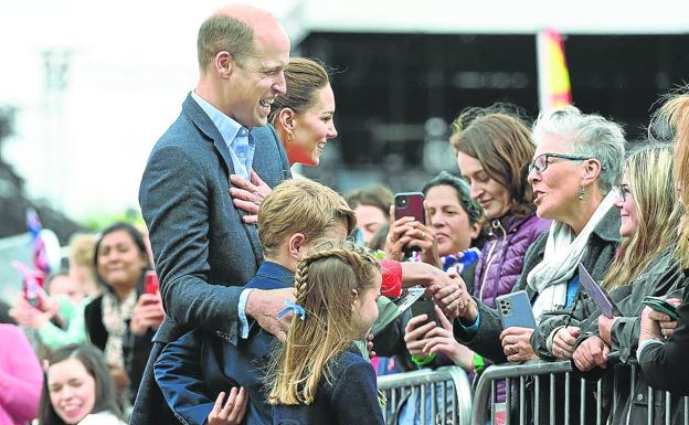 William of Cambridge, Catherine and two of their children joke with a group of citizens during the events held in June for the Queen's Jubilee. 