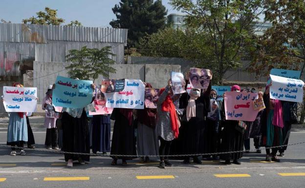 Afghan women protest in front of the Iranian embassy in Kabul, before being dispersed by the Taliban.