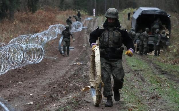 Polish soldiers install a barbed wire fence along the border with the Russian enclave of Kaliningrad. 