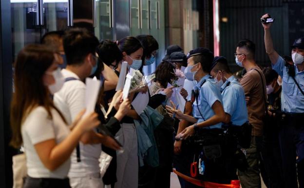 Police officers confront protesters during a day of protests against China's 'zero covid' policy, in Hong Kong. 