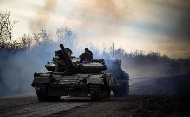 A Ukrainian tank drives along a road near Bakhmut in the Donetsk region. 