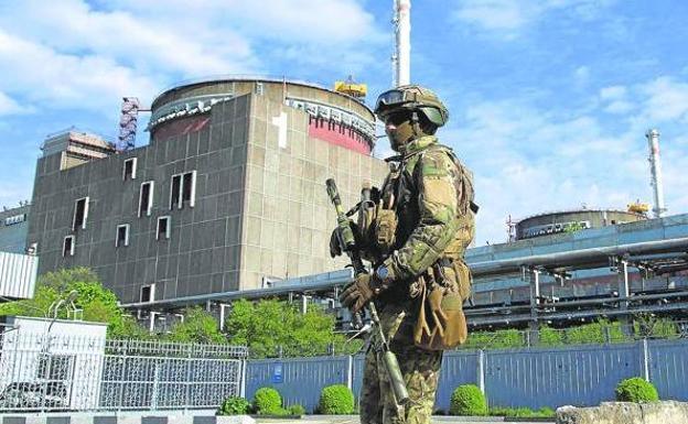 A Russian soldier patrols around the Zaporizhia nuclear power plant. 